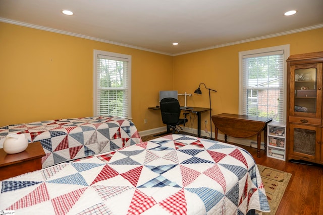 bedroom with hardwood / wood-style flooring, multiple windows, and ornamental molding