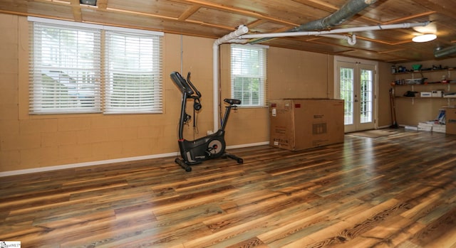 workout room with plenty of natural light, french doors, hardwood / wood-style floors, and wood ceiling