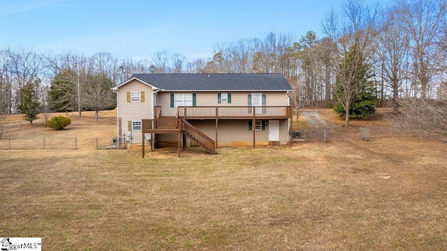 rear view of property featuring a deck and a yard