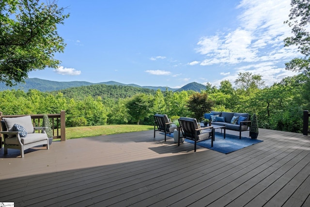 wooden deck featuring an outdoor hangout area and a mountain view