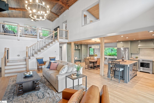 living room featuring high vaulted ceiling, wood ceiling, and light hardwood / wood-style flooring