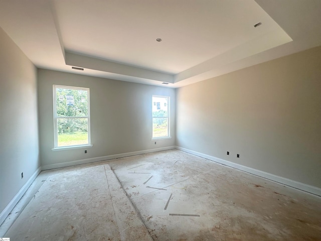 unfurnished room with a tray ceiling