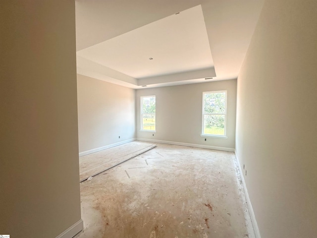 spare room featuring a tray ceiling