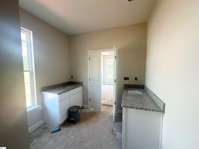 interior space with white cabinets and sink