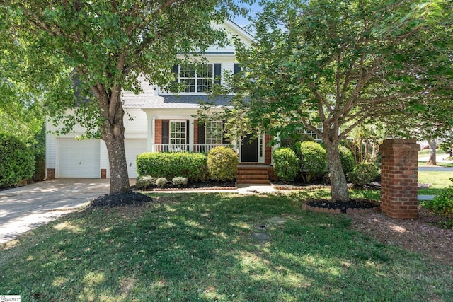 view of front of property featuring a garage and a front yard