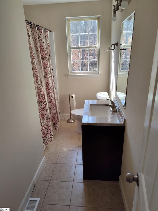 bathroom featuring toilet, vanity, and tile patterned floors