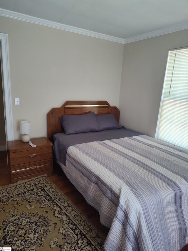 bedroom with hardwood / wood-style flooring and crown molding