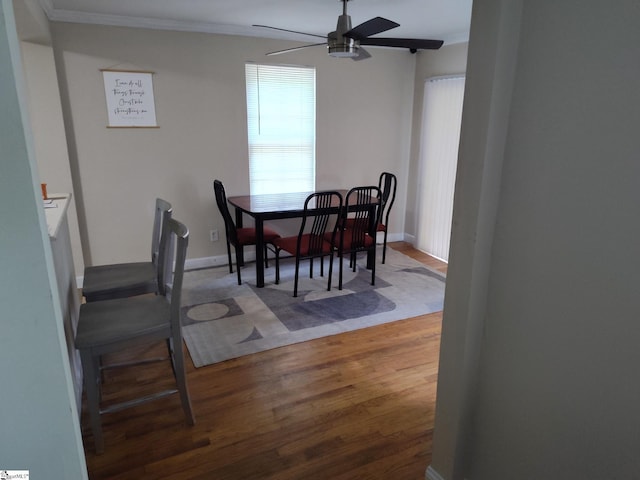 dining area featuring ceiling fan, crown molding, and wood-type flooring