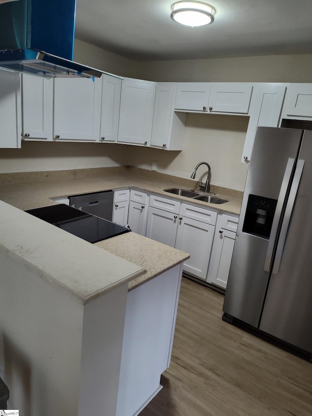 kitchen with light wood-type flooring, white cabinets, light stone counters, sink, and stainless steel appliances