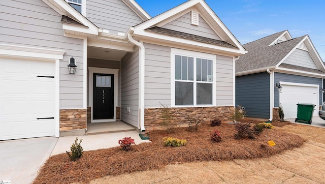 property entrance with stone siding and an attached garage