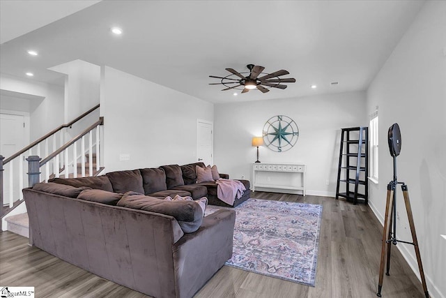 living room featuring ceiling fan and light hardwood / wood-style floors