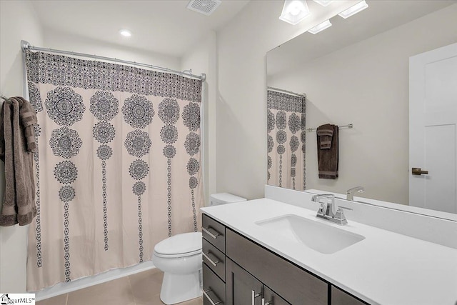 bathroom featuring tile patterned floors, vanity, and toilet