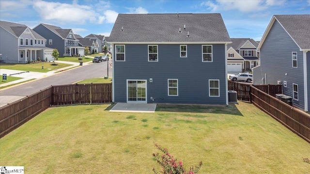 back of house featuring a patio area, a yard, and central AC