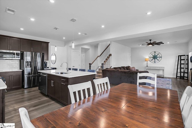 dining room with ceiling fan, dark hardwood / wood-style floors, and sink