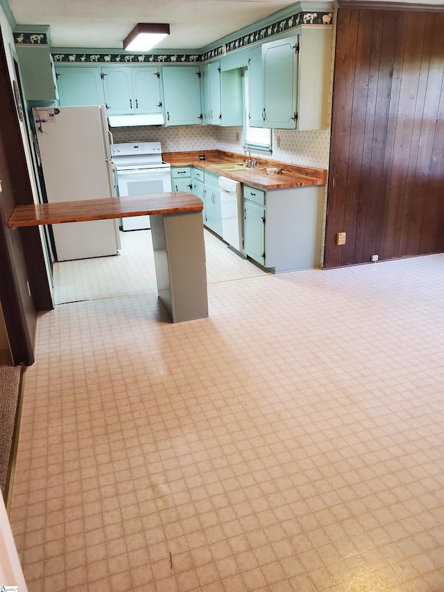 kitchen with sink, white appliances, and light tile patterned floors