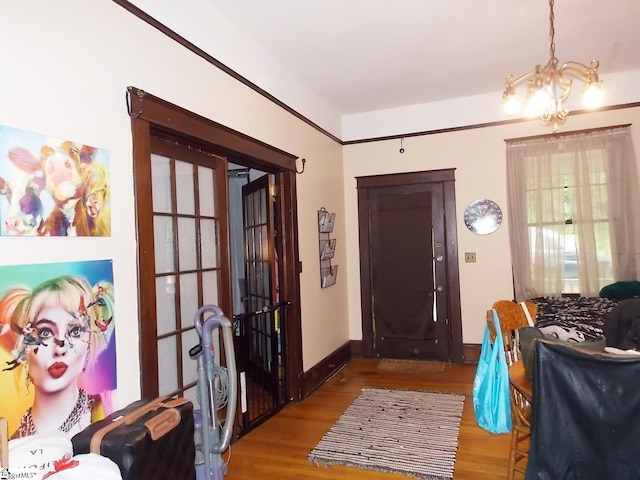 entryway featuring a notable chandelier, french doors, and light hardwood / wood-style flooring