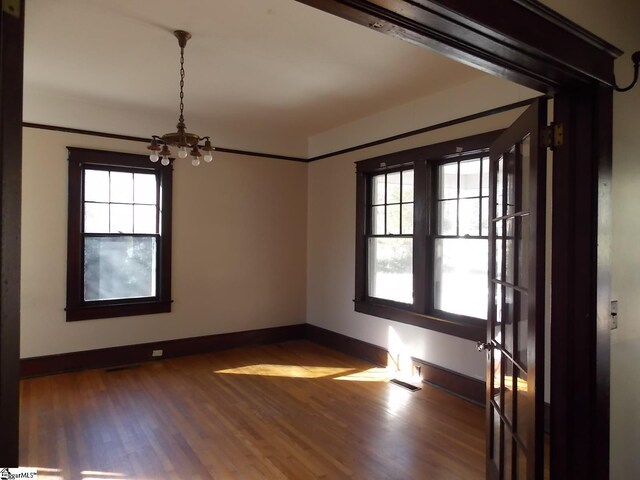 living room with a chandelier, hardwood / wood-style flooring, and cooling unit