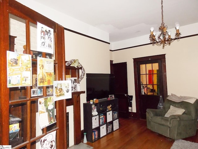 living room with dark hardwood / wood-style floors and a notable chandelier