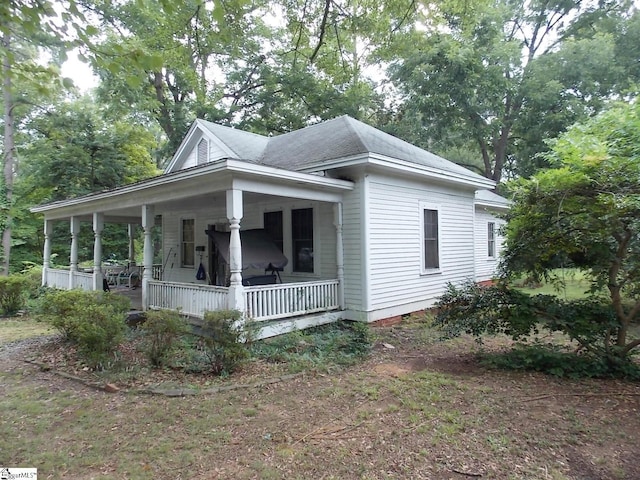 view of side of property featuring a porch