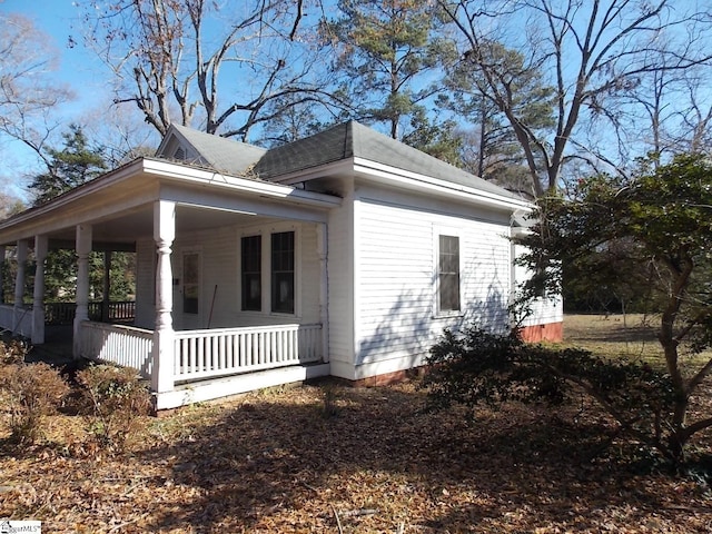 view of side of property featuring a porch