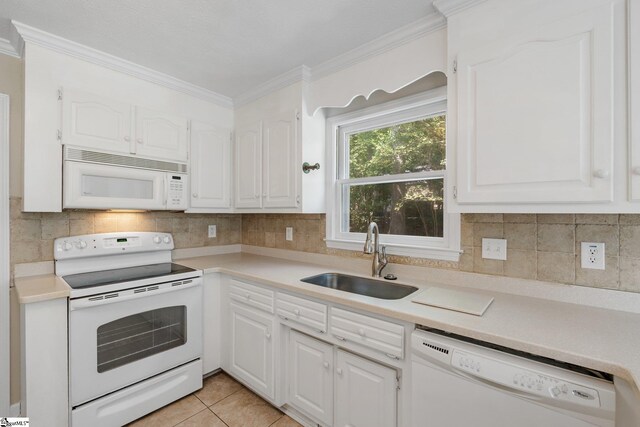 kitchen with white cabinetry, sink, crown molding, and white appliances