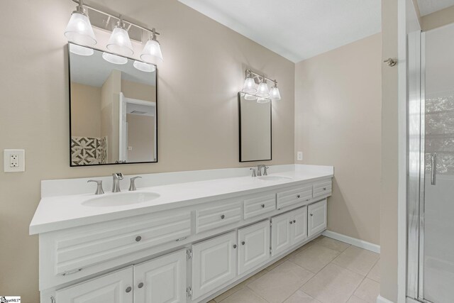 bathroom with double vanity and tile patterned floors