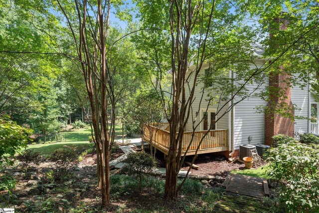 view of yard with a deck and cooling unit