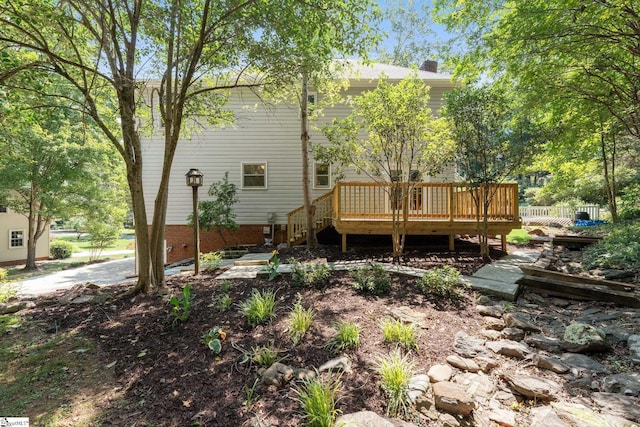 rear view of property with a wooden deck