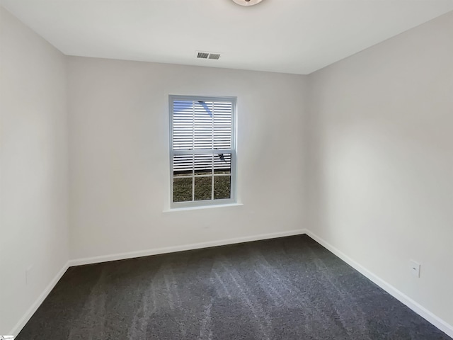 carpeted spare room with visible vents and baseboards