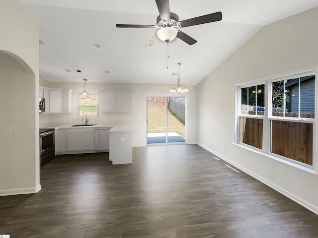 kitchen featuring a sink, white cabinetry, open floor plan, light countertops, and stainless steel electric range oven