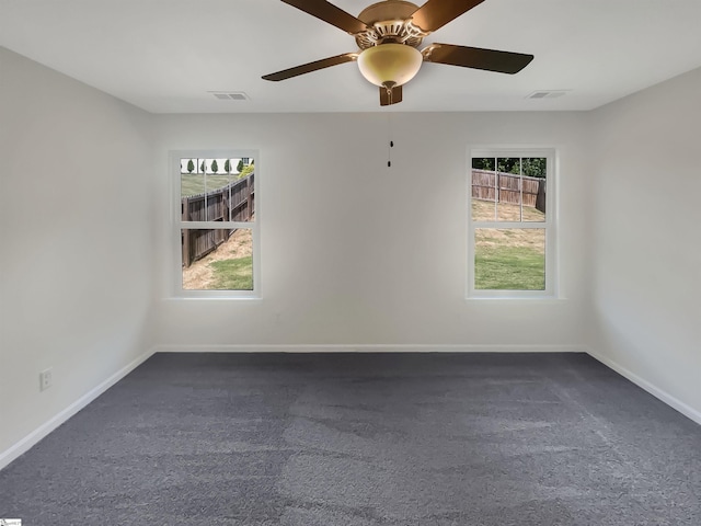 unfurnished room featuring visible vents, plenty of natural light, and baseboards