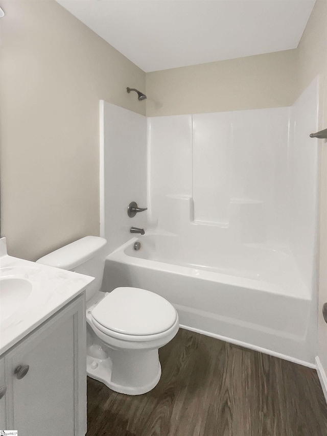 full bathroom with toilet, shower / bath combination, wood finished floors, and vanity