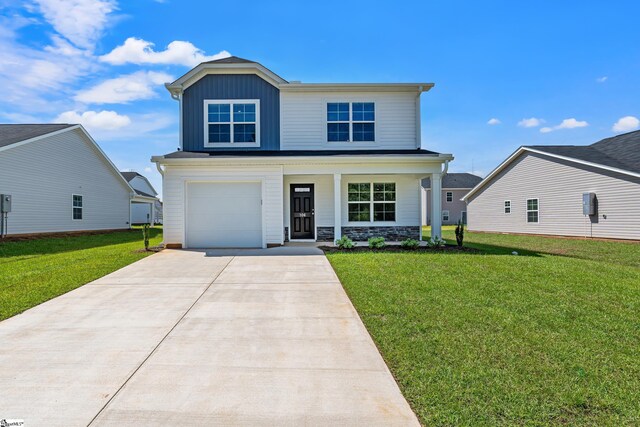 view of front of home featuring a garage and a yard