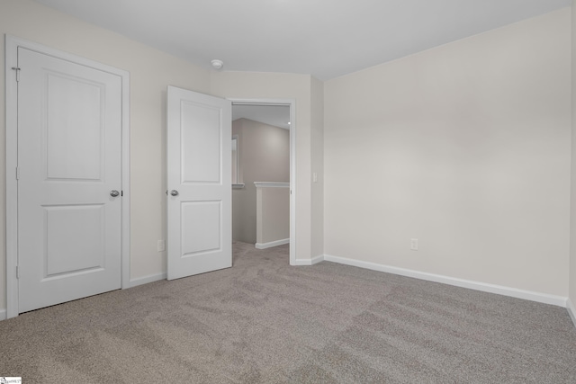 unfurnished bedroom with light colored carpet