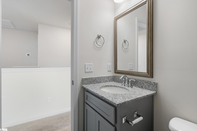 bathroom featuring vanity and toilet