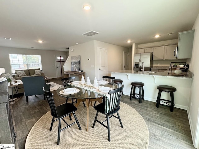 dining room featuring wood-type flooring and sink