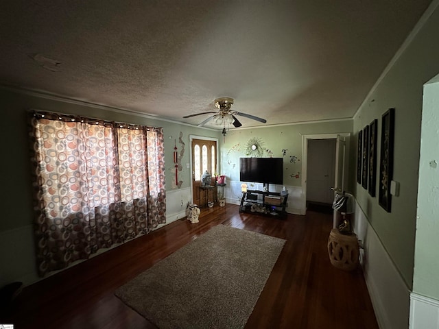 living room with ceiling fan, dark hardwood / wood-style flooring, and a textured ceiling