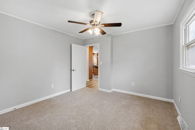 spare room featuring crown molding, light colored carpet, and ceiling fan