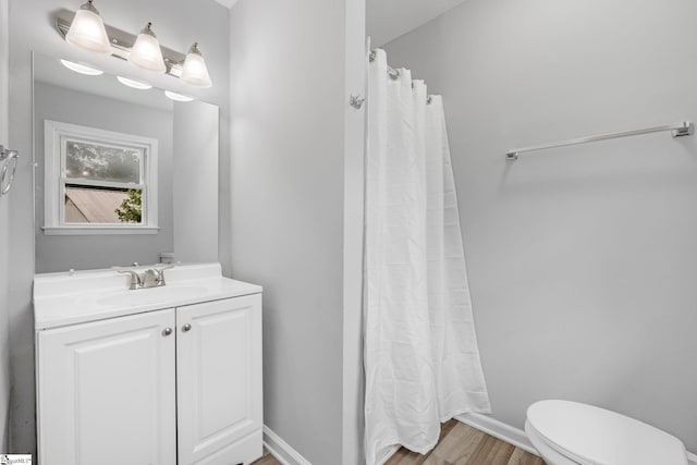 bathroom featuring toilet, vanity, a shower with shower curtain, and wood-type flooring