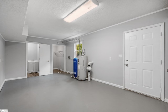 interior space with a textured ceiling, water heater, and crown molding