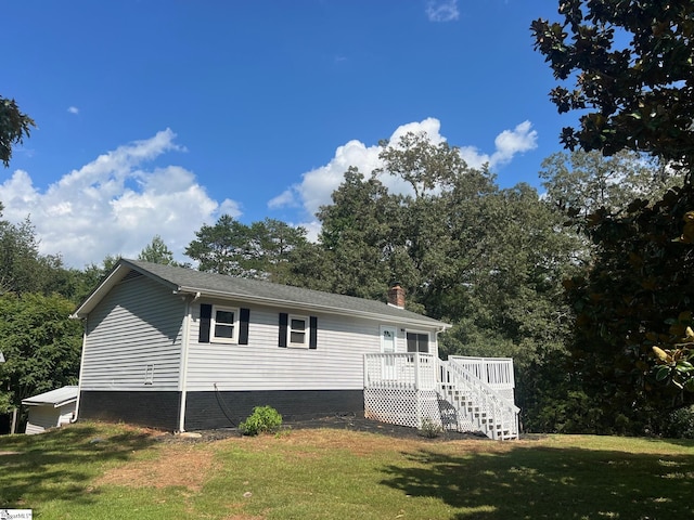 view of front facade featuring a deck and a front yard