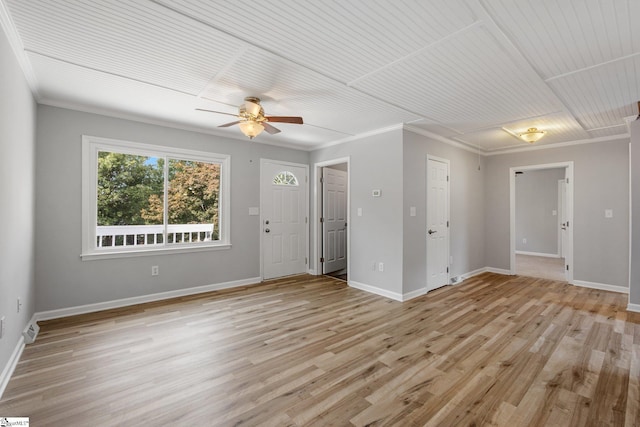 spare room with ceiling fan, ornamental molding, light hardwood / wood-style floors, and wood ceiling