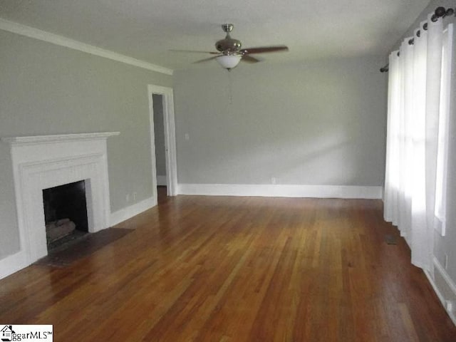 unfurnished living room featuring ceiling fan, ornamental molding, and wood-type flooring