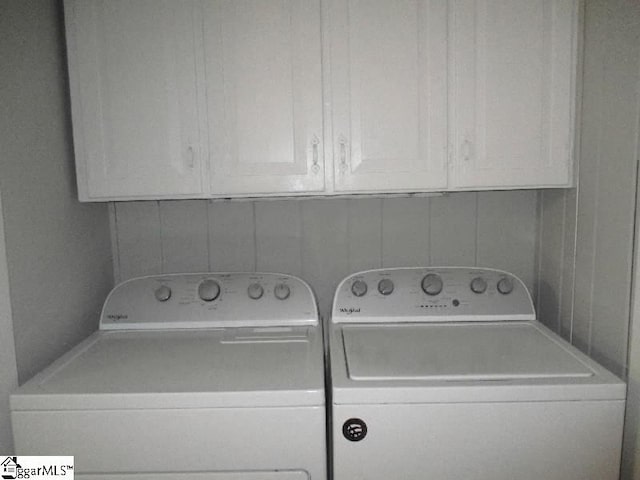 laundry area featuring cabinets and washer and clothes dryer