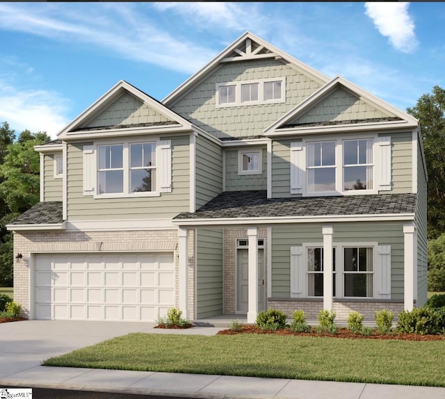 craftsman house featuring a garage and a front lawn