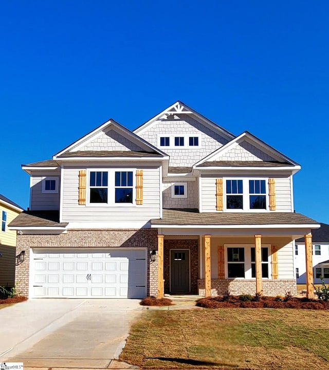 333 Alyssa Landing Dr Unit 72, Fountain Inn, SC 29644 - view of front of home featuring driveway, an attached garage, a front lawn, brick siding, and covered porch