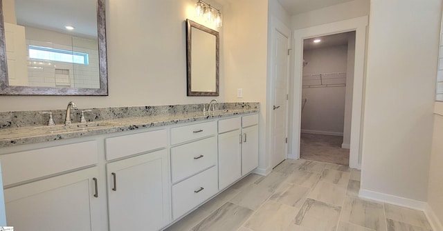 333 Alyssa Landing Dr Unit 72, Fountain Inn, SC 29644 - bathroom with a walk in closet, double vanity, recessed lighting, and baseboards