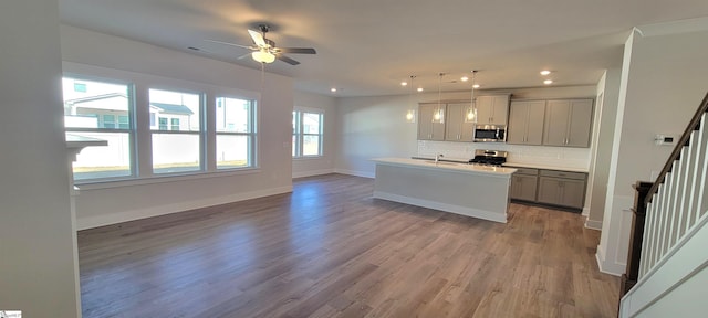 333 Alyssa Landing Dr Unit 72, Fountain Inn, SC 29644 - kitchen with stainless steel microwave, range with gas cooktop, backsplash, open floor plan, and recessed lighting