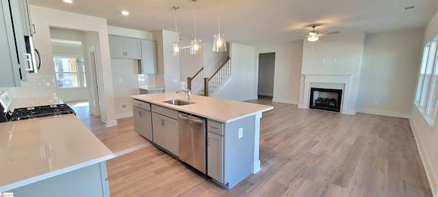 333 Alyssa Landing Dr Unit 72, Fountain Inn, SC 29644 - kitchen featuring stainless steel appliances, a sink, a ceiling fan, tasteful backsplash, and gray cabinetry