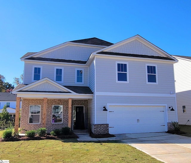 view of front of property featuring a front lawn, an attached garage, and driveway